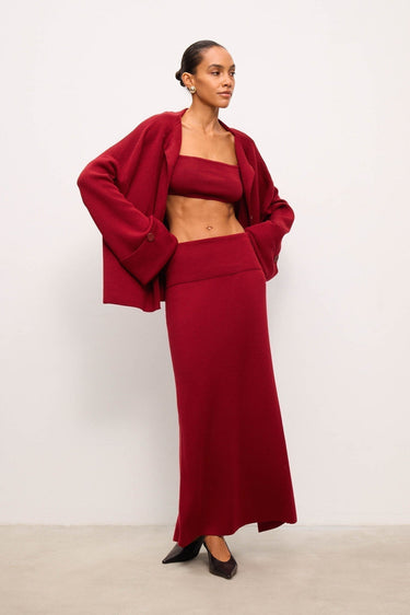 Woman wearing a red outfit against a white background