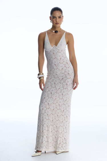 Woman wearing a white lace dress on a white background