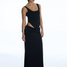 Woman wearing a black evening gown with cut-out design on a white background