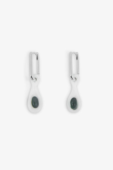 Pair of earrings with dark gemstones on a white background