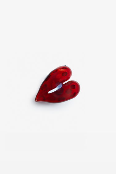Red heart-shaped object on a white background